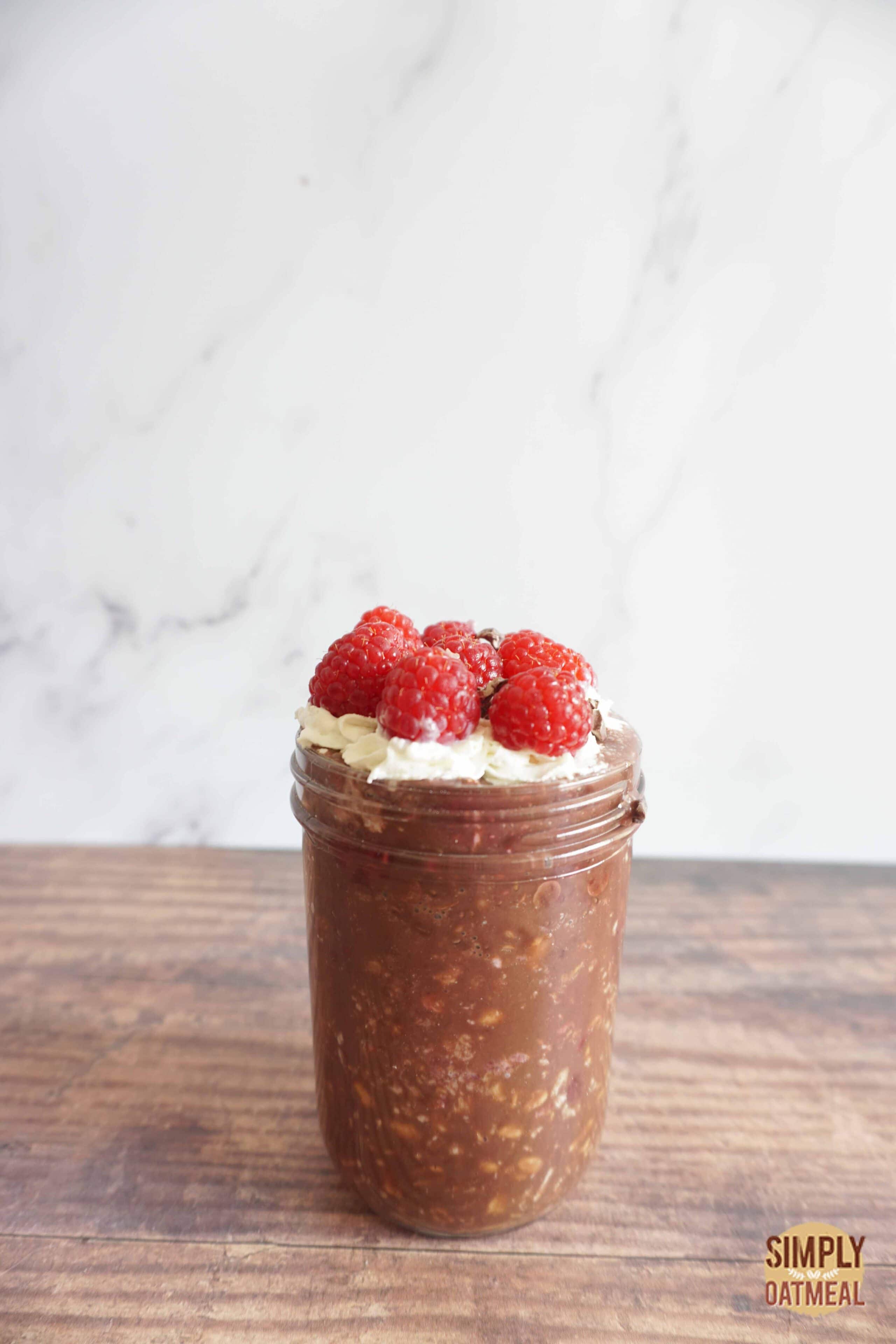 Serving of raspberry mocha overnight oats in a mason jar.