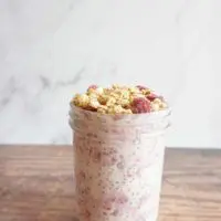 Single serving of raspberry vanilla overnight oats in a mason jar.