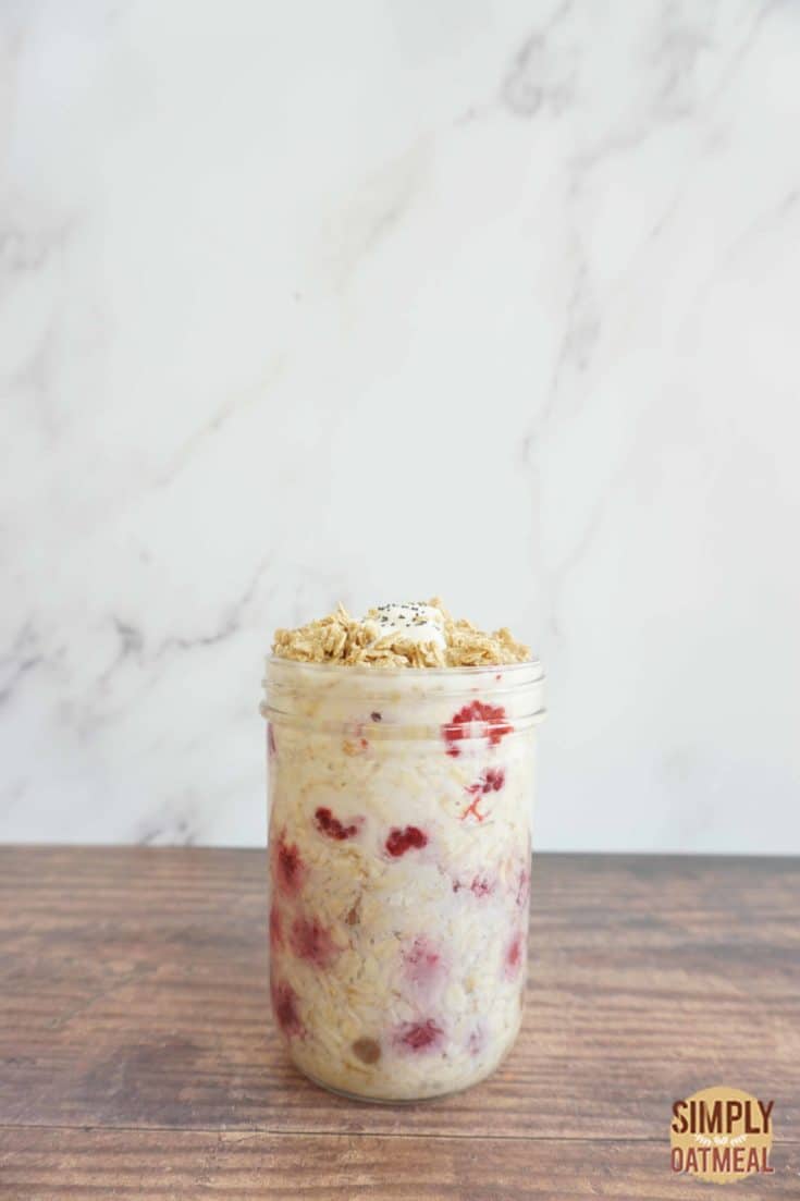 One serving of raspberry yogurt overnight oats in a glass jar