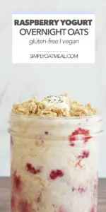 Glass bowl with a serving of raspberry yogurt overnight oats garnished with raspberries, yogurt and granola.