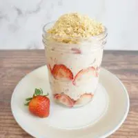 One serving of strawberry shortcake overnight oats in a glass jar