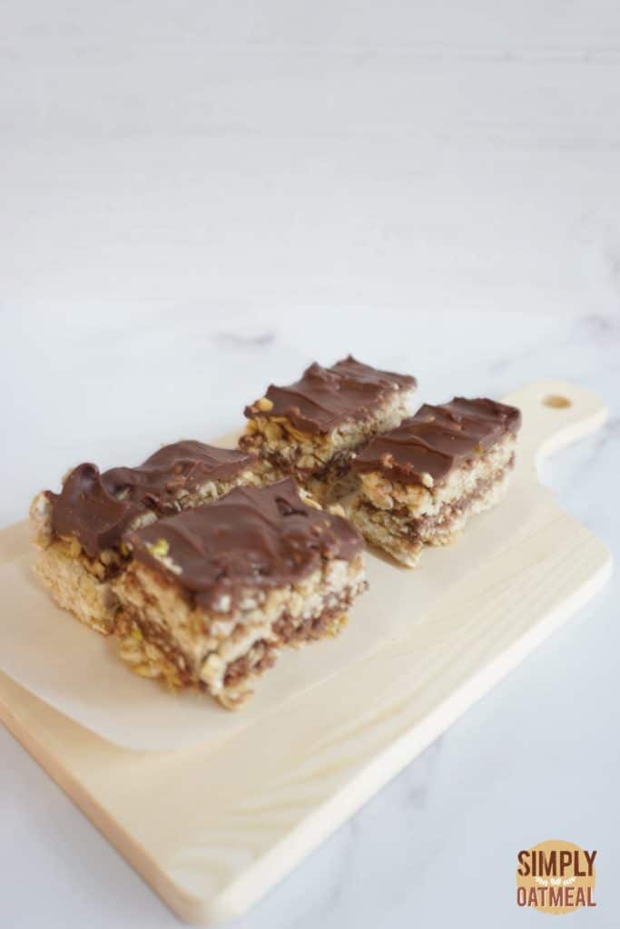 No bake chocolate pretzel oatmeal bars on a wooden cutting board