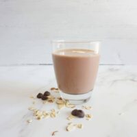 Single serving of almond joy oatmeal smoothie in a glass cup