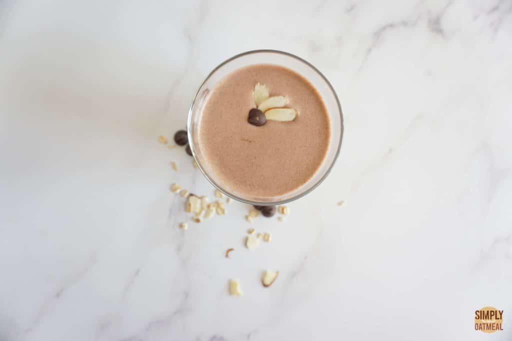 Almond joy oatmeal smoothie topped with sliced almonds and mini chocolate chips