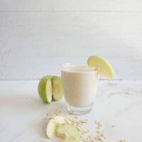 Serving of apple pie oatmeal smoothie in a glass cup
