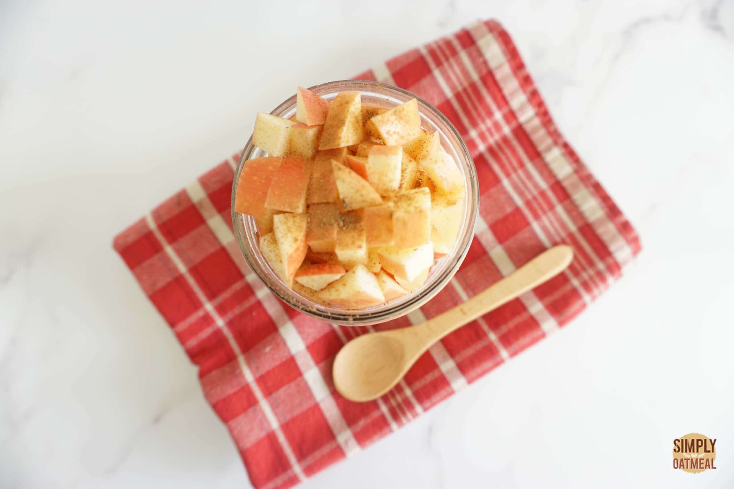 Apple raspberry overnight oats topped with diced apple and a dash of cinnamon.