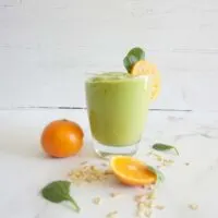 Single serving of avocado dreamsicle oatmeal smoothie in a glass cup.