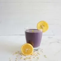 Single serving of blueberry lemon oatmeal smoothie in a glass cup