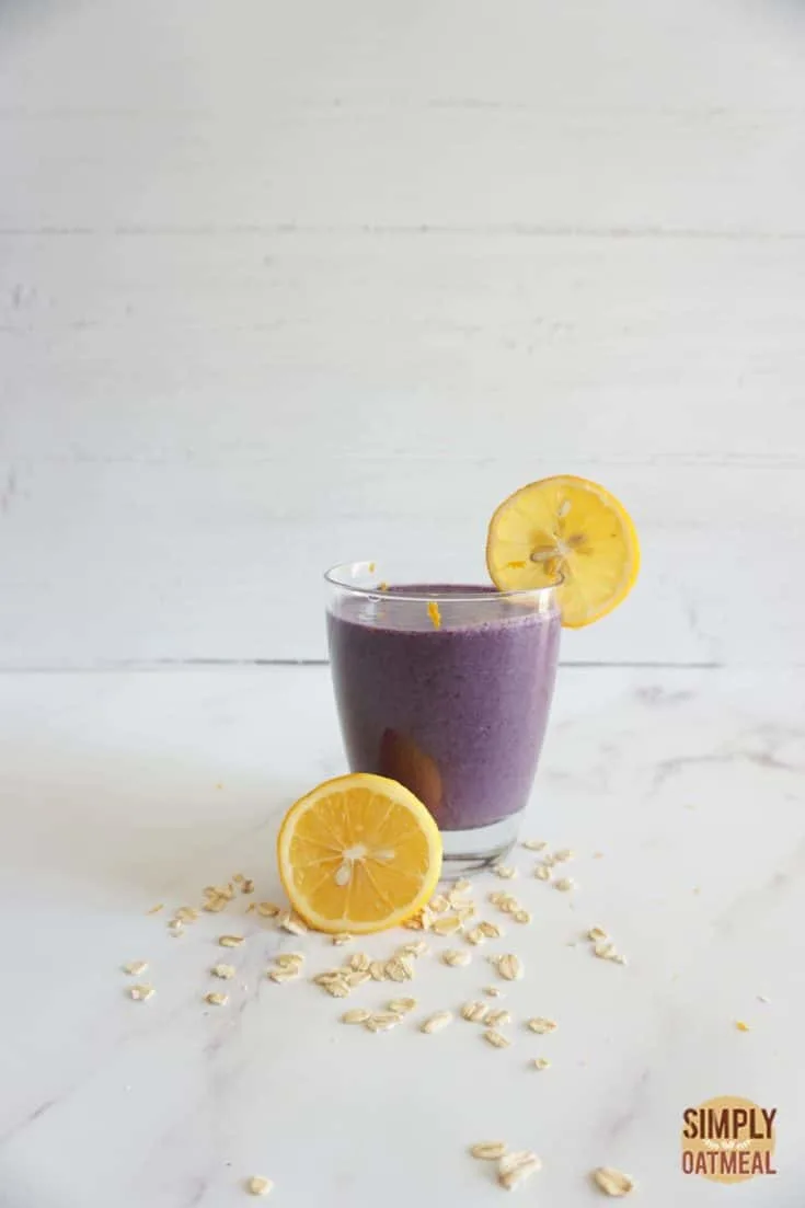 Single serving of blueberry lemon oatmeal smoothie in a glass cup