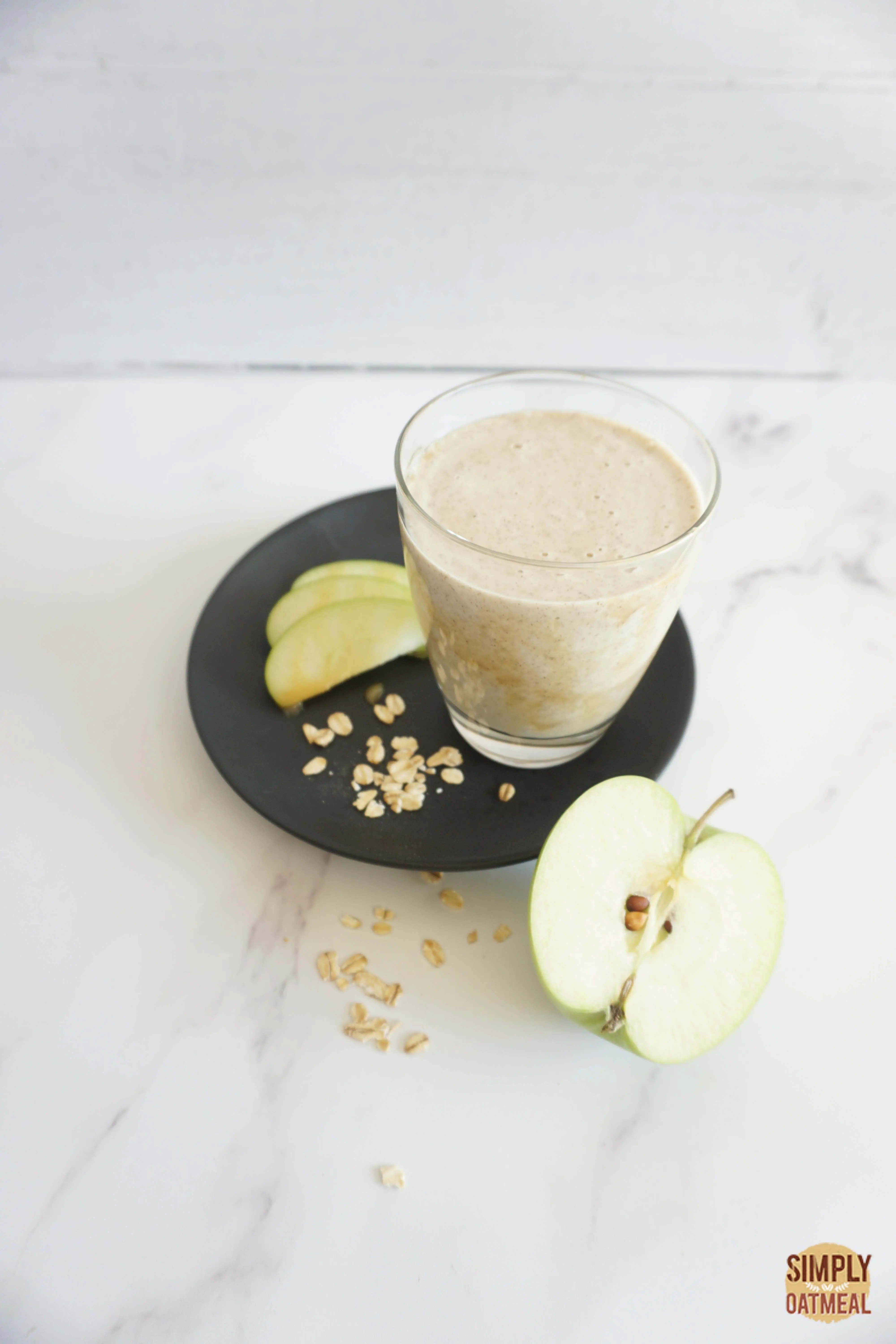 Caramel apple oatmeal smoothie served in a mason jar with a green apple on the side