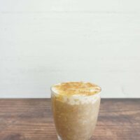 Serving of cinnamon dolce latte overnight oats in a glass jar.