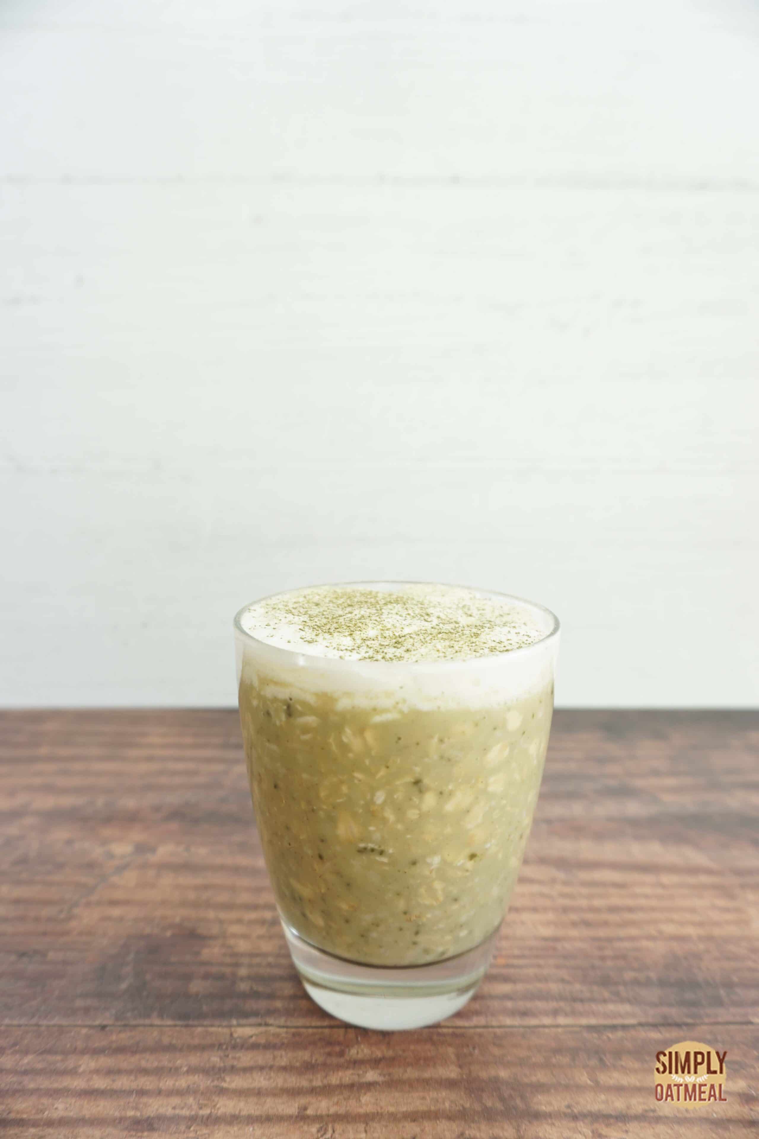 Glass jar with one serving of green tea latte overnight oats.