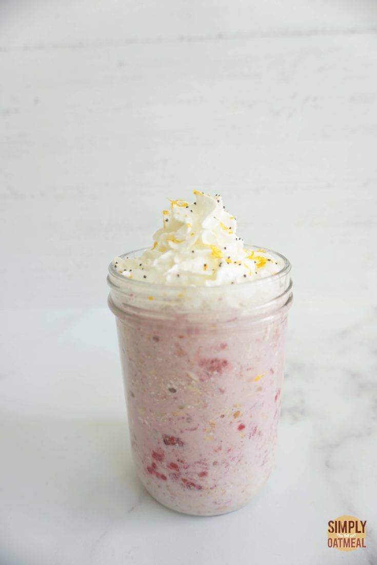 Mason jar filled with one serving of lemon raspberry overnight oats.