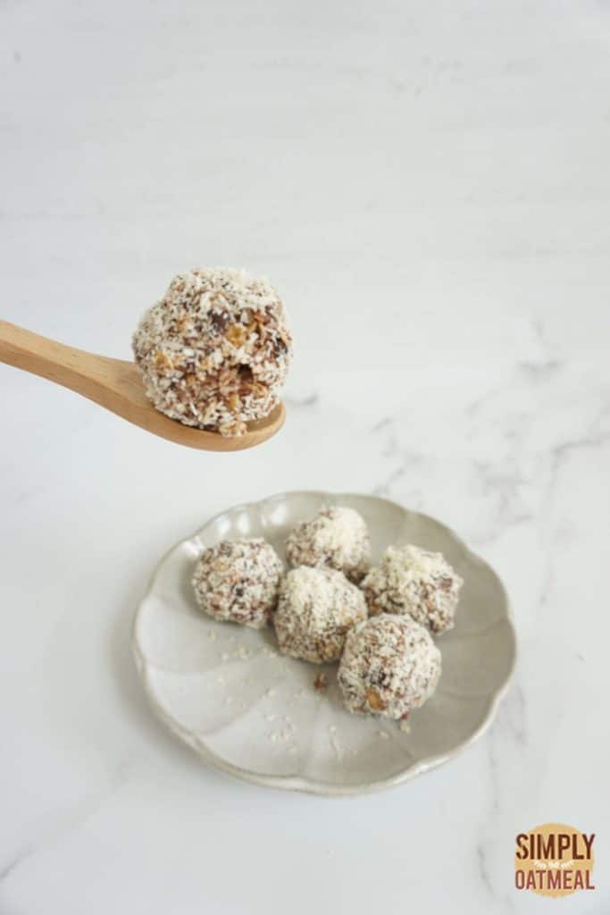 No bake almond joy oatmeal ball on a wooden spoon.