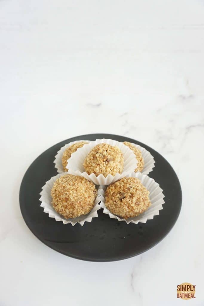 5 no bake banana walnut oatmeal balls on a black plate