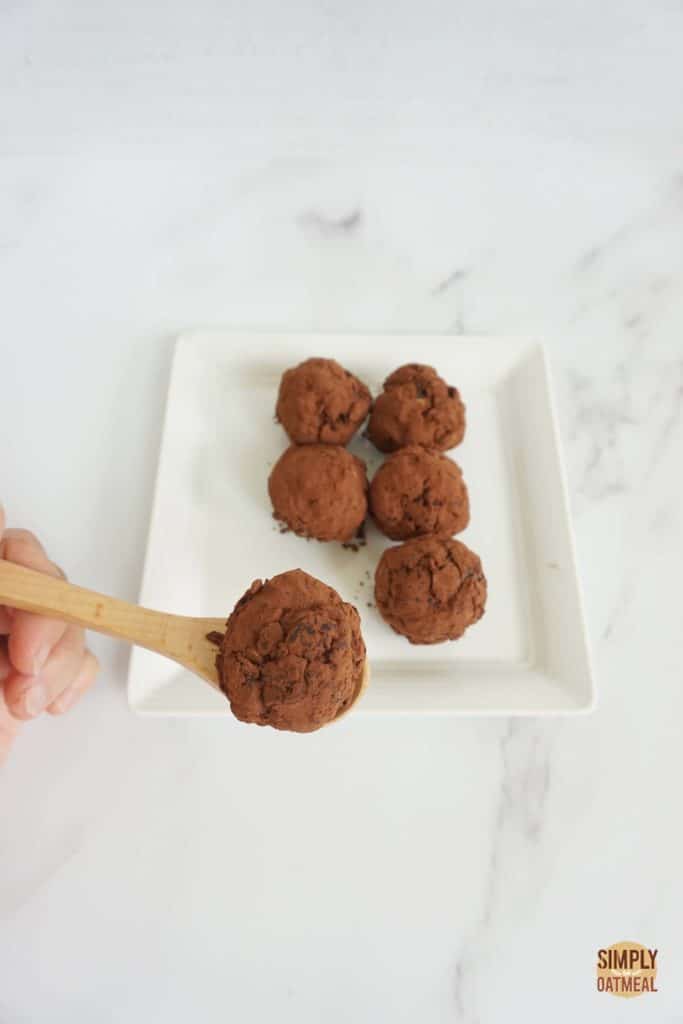 no bake chocolate oatmeal ball on a wooden spoon