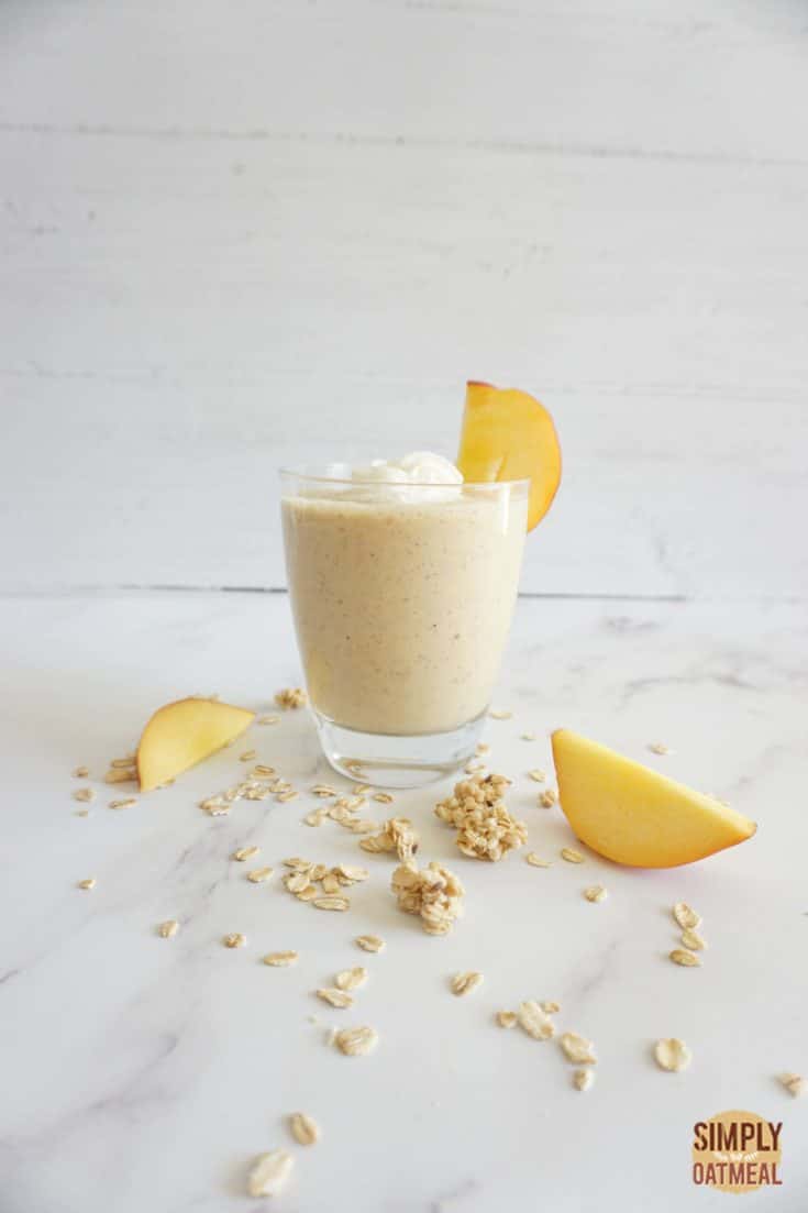 Single serving of peach cobbler oatmeal smoothie in a glass cup.