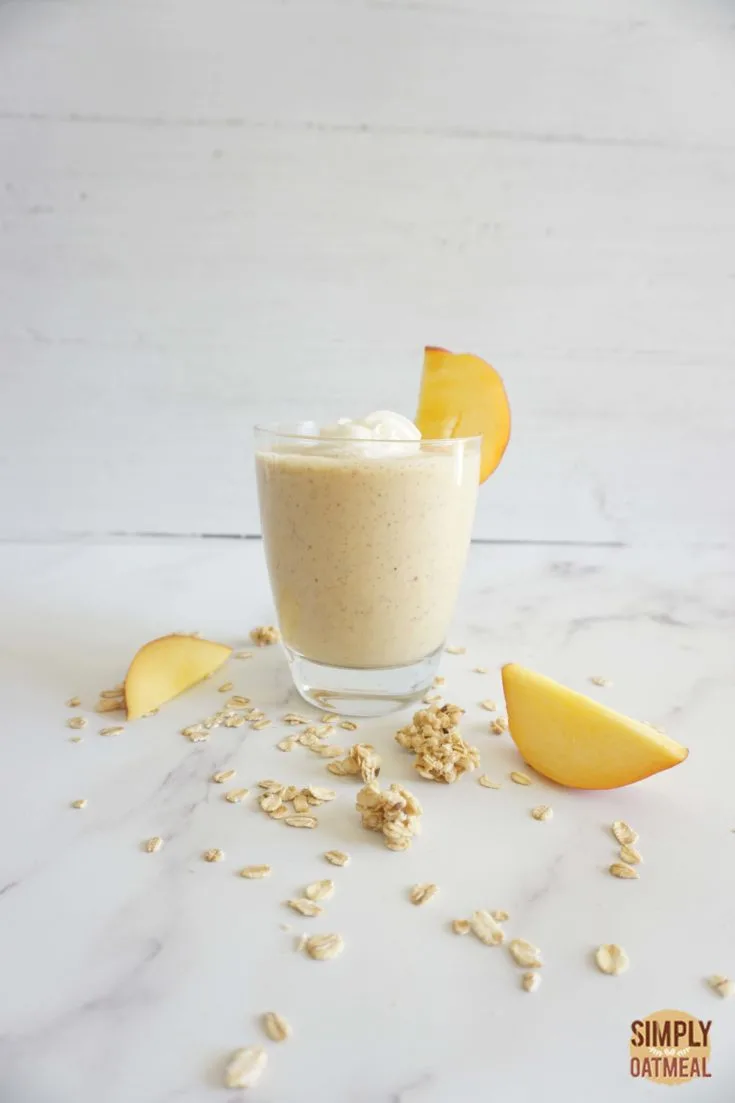 Single serving of peach cobbler oatmeal smoothie in a glass cup.