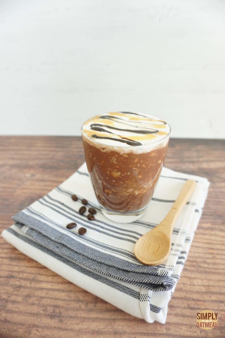 One serving of salted caramel mocha overnight oats in a clear glass cup.
