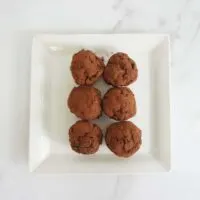 6 no bake chocolate oatmeal balls on a white plate