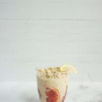 Single serving of blood orange lemonade overnight oats in a glass cup
