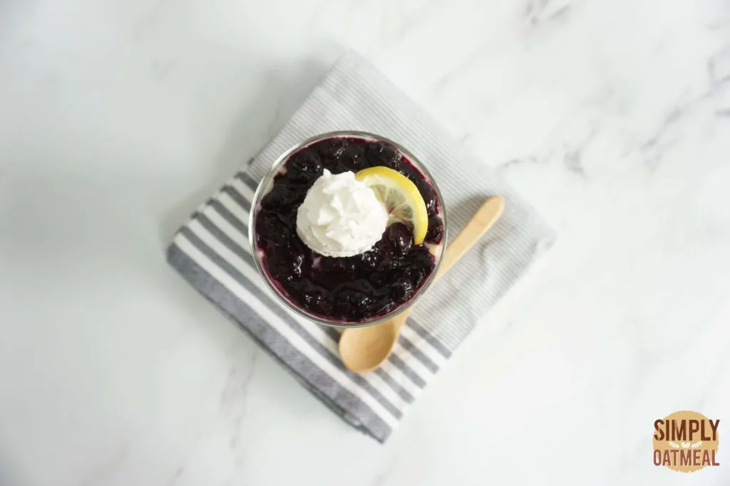 Oats Blueberry lemonade overnight oats served in a mason jar garnished with lemon zest and sliced lemon
