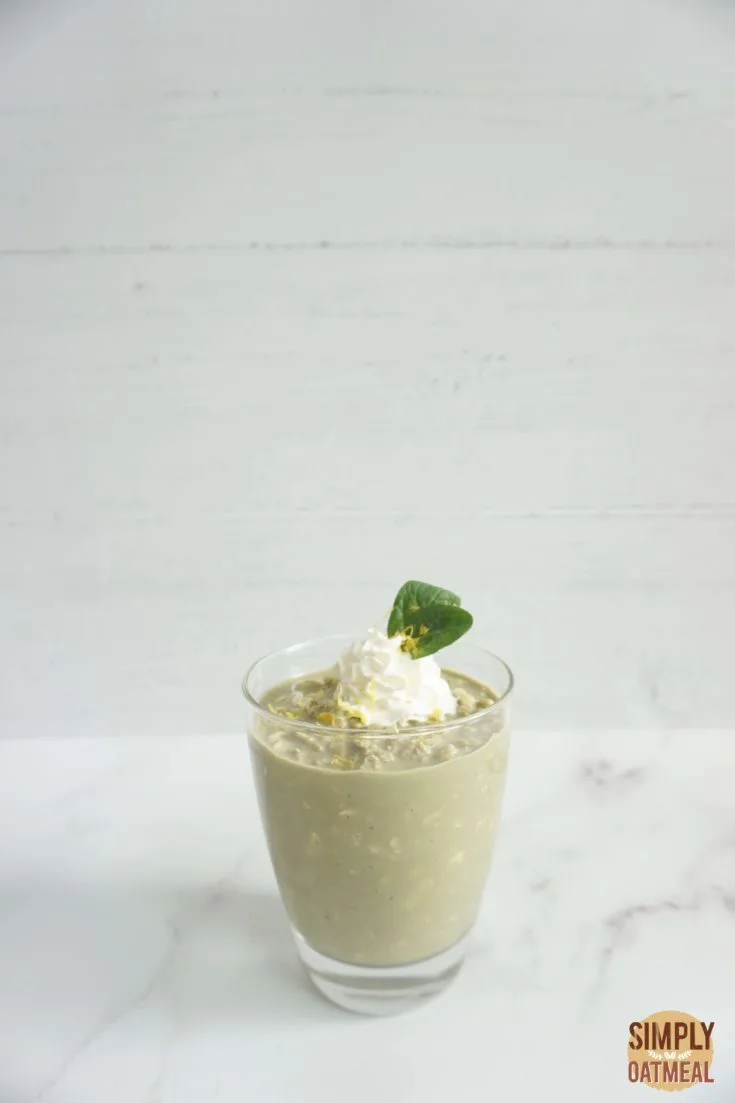 Single serving of green tea lemonade overnight oats garnished with fresh mint and lemon zest
