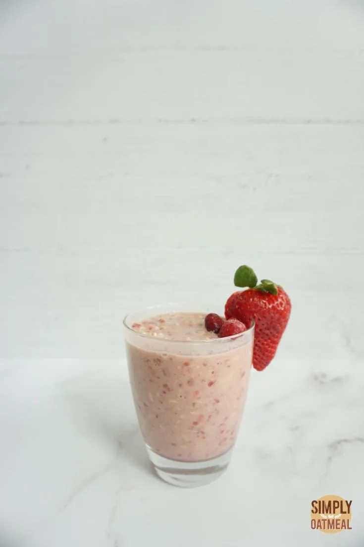 Single serving of pink lemonade overnight oats in a glass cup