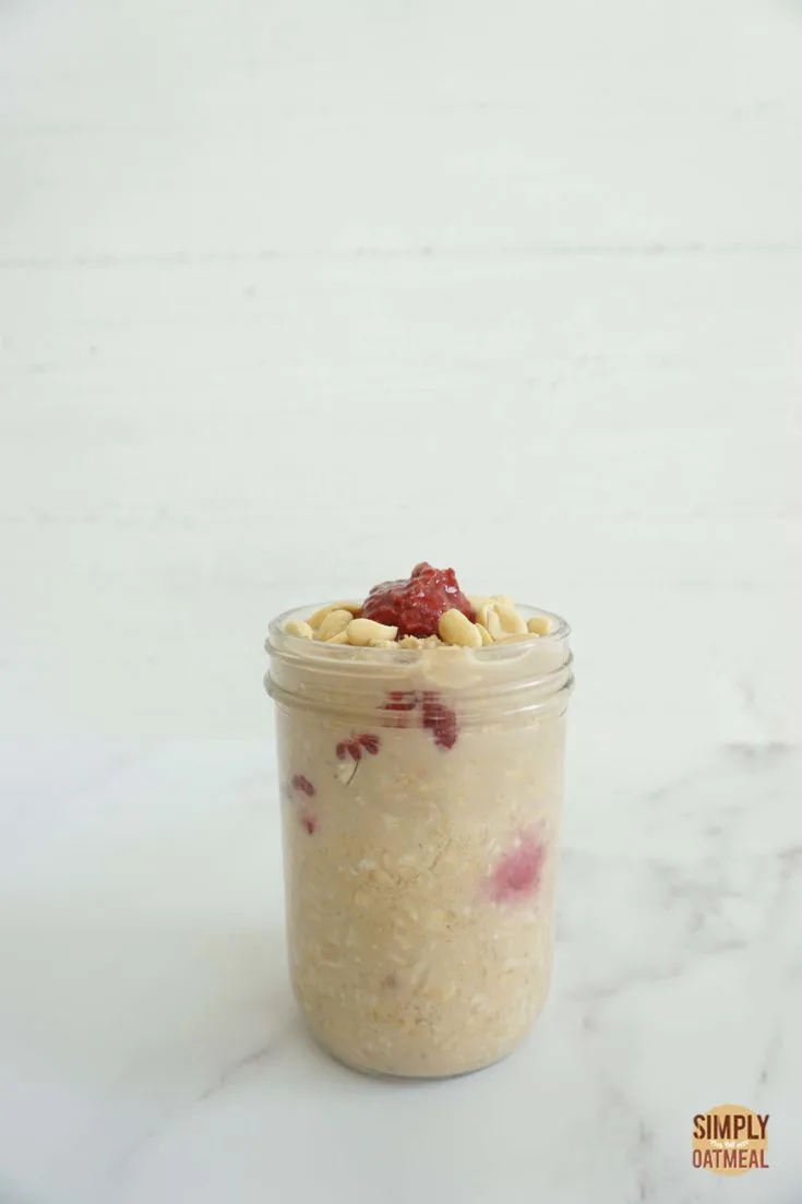 Single serving of raspberry peanut butter overnight oats in a mason jar