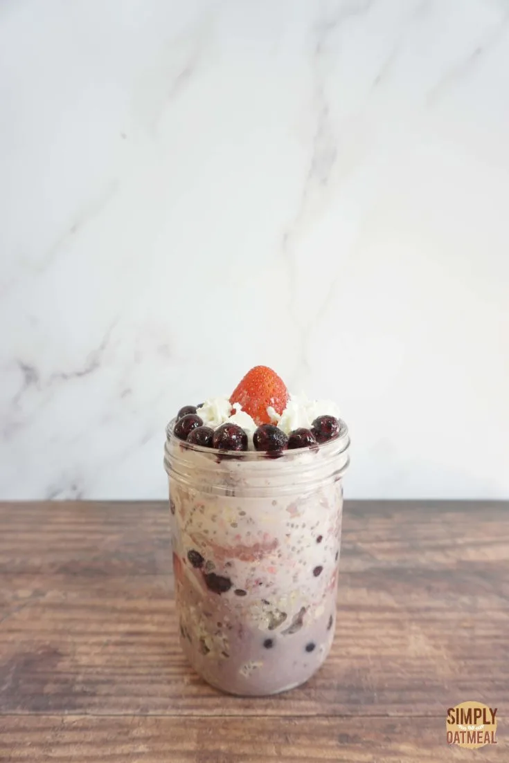 Single serving of strawberry blueberry overnight oats in a mason jar