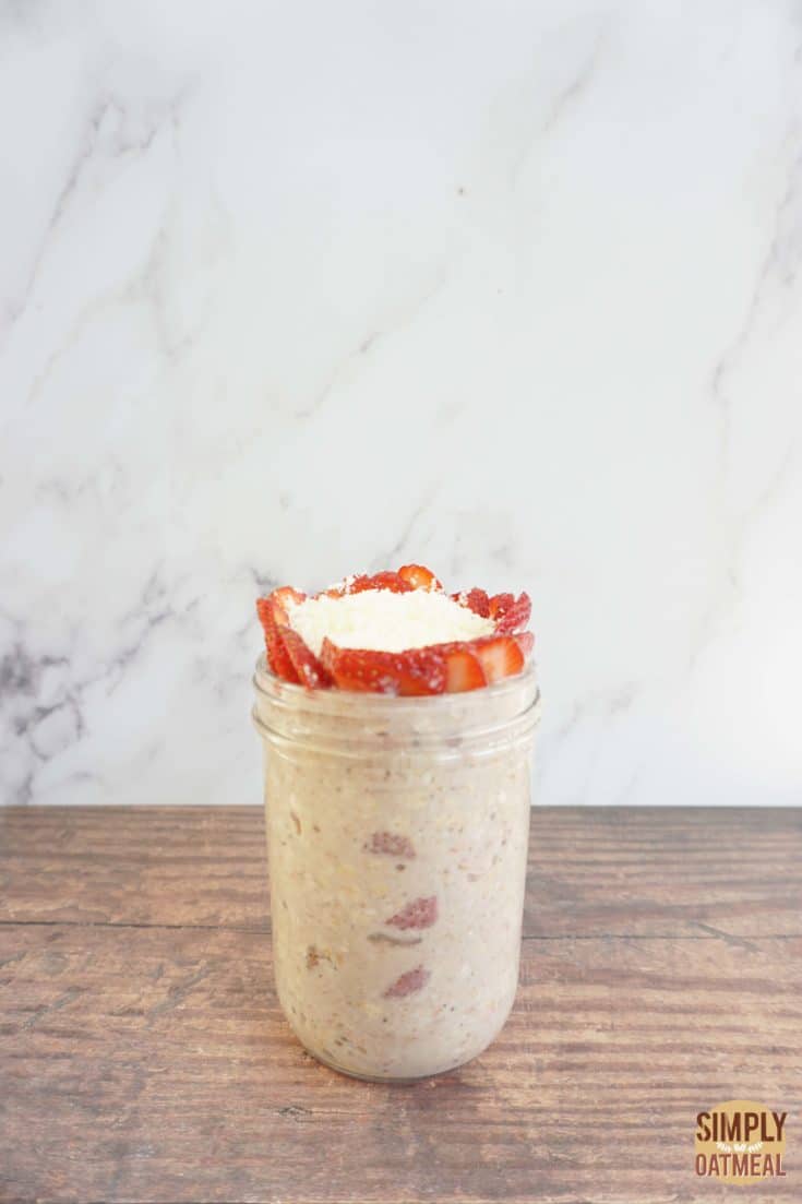 Single serving of strawberry coconut overnight oats in a mason jar.