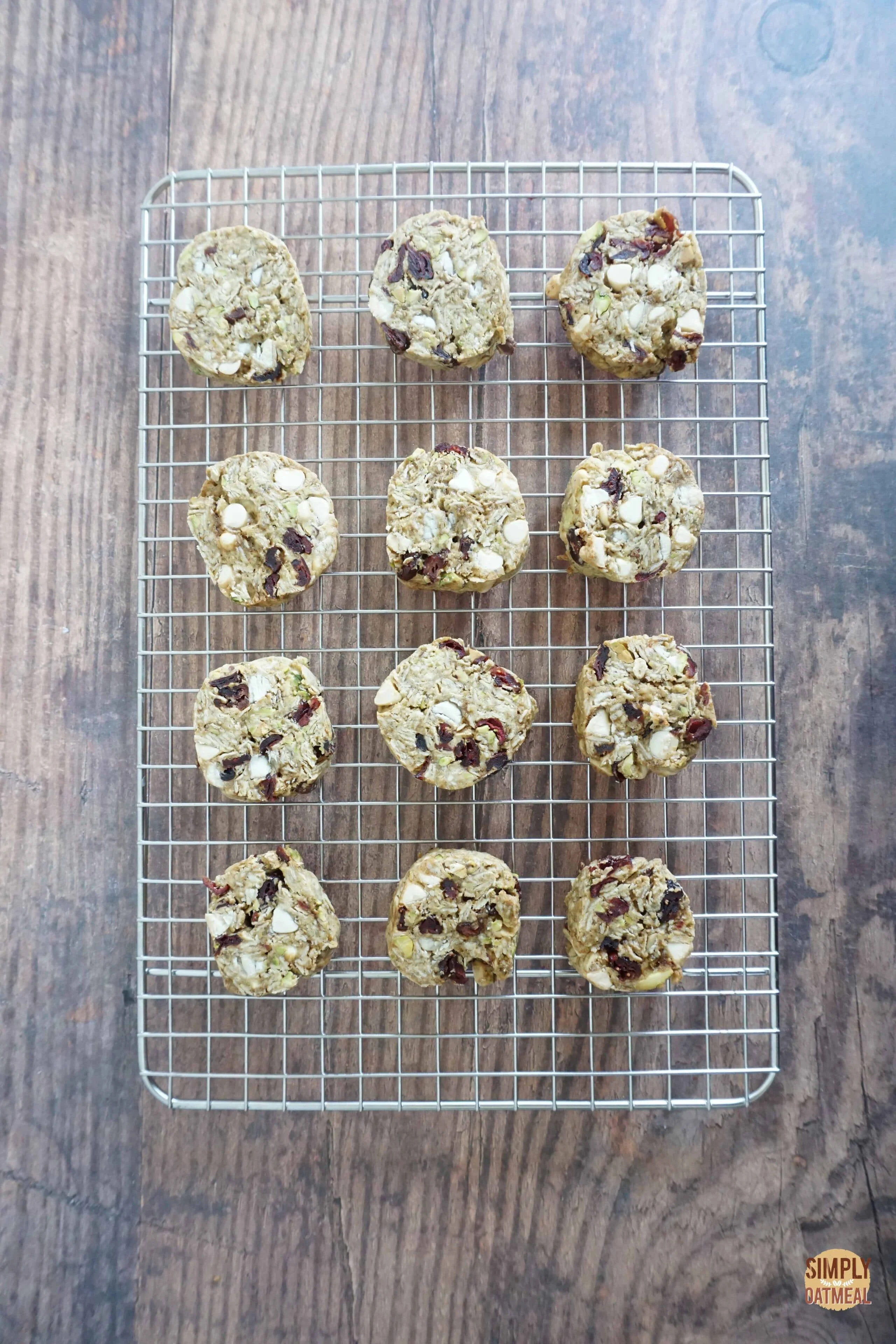 Fresh baked white chocolate cherry oatmeal cookies on a wire rack