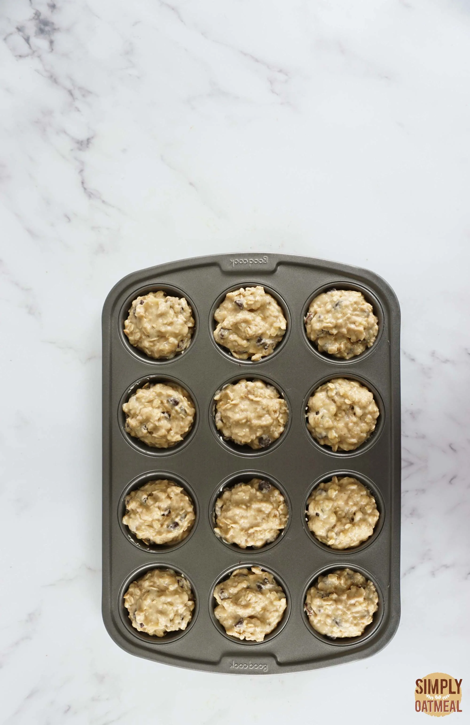 Applesauce oatmeal muffins batter in a prepared muffin pan