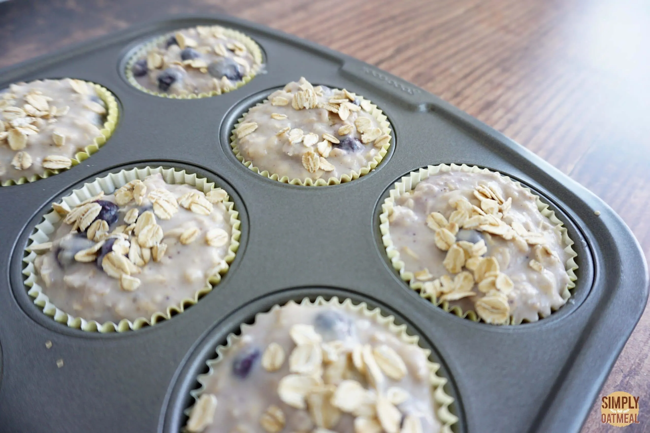 Baked blueberry lemon oatmeal muffins in a muffin pan