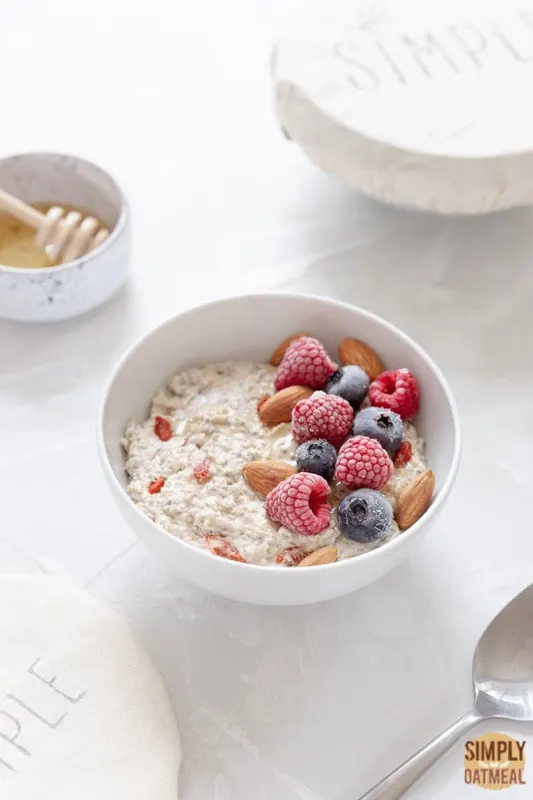 Bowl of overnight oats with almonds and berries on top Bowl of overnight oats with almonds and berries on top