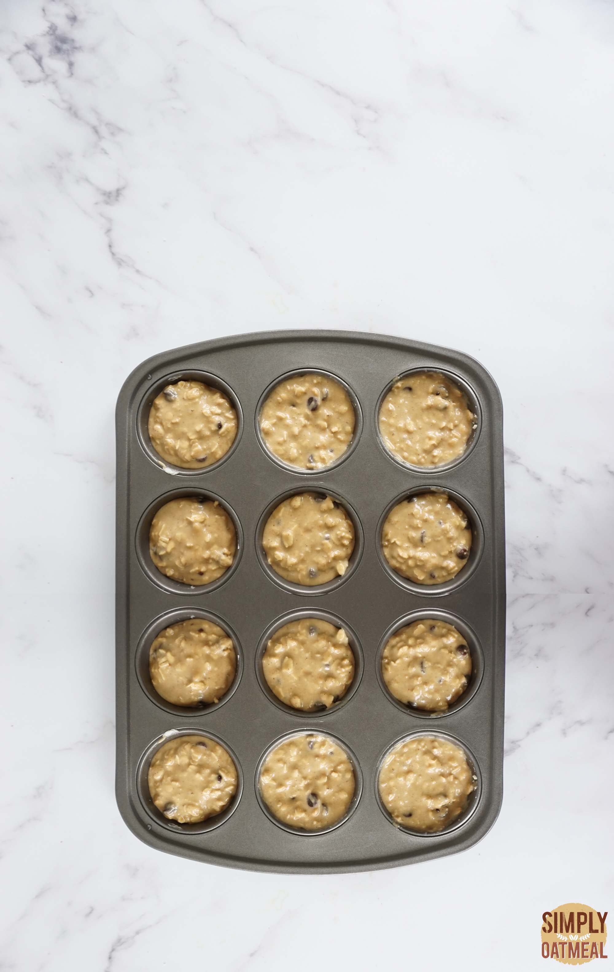 Chocolate chip oatmeal muffins batter in a muffin pan