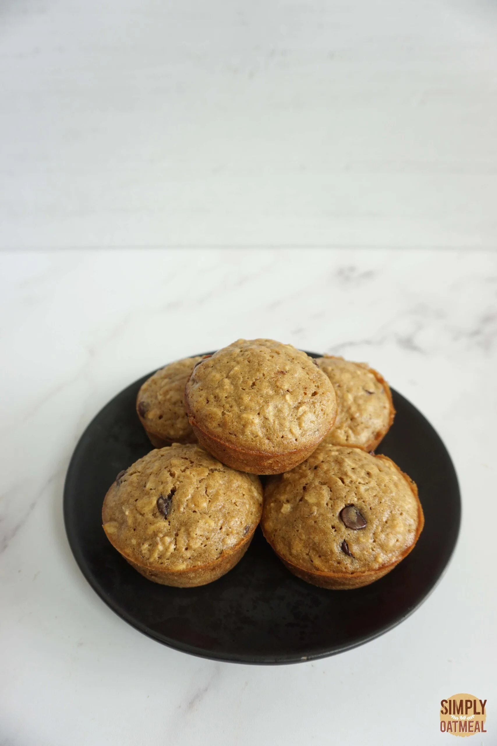 Fresh baked chocolate chip oatmeal muffins on a plate