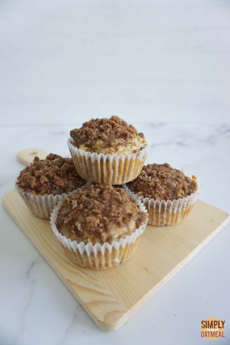 Fresh baked cinnamon streusel oatmeal muffins on a wooden plate