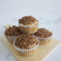 Fresh baked cinnamon streusel oatmeal muffins on a wooden plate