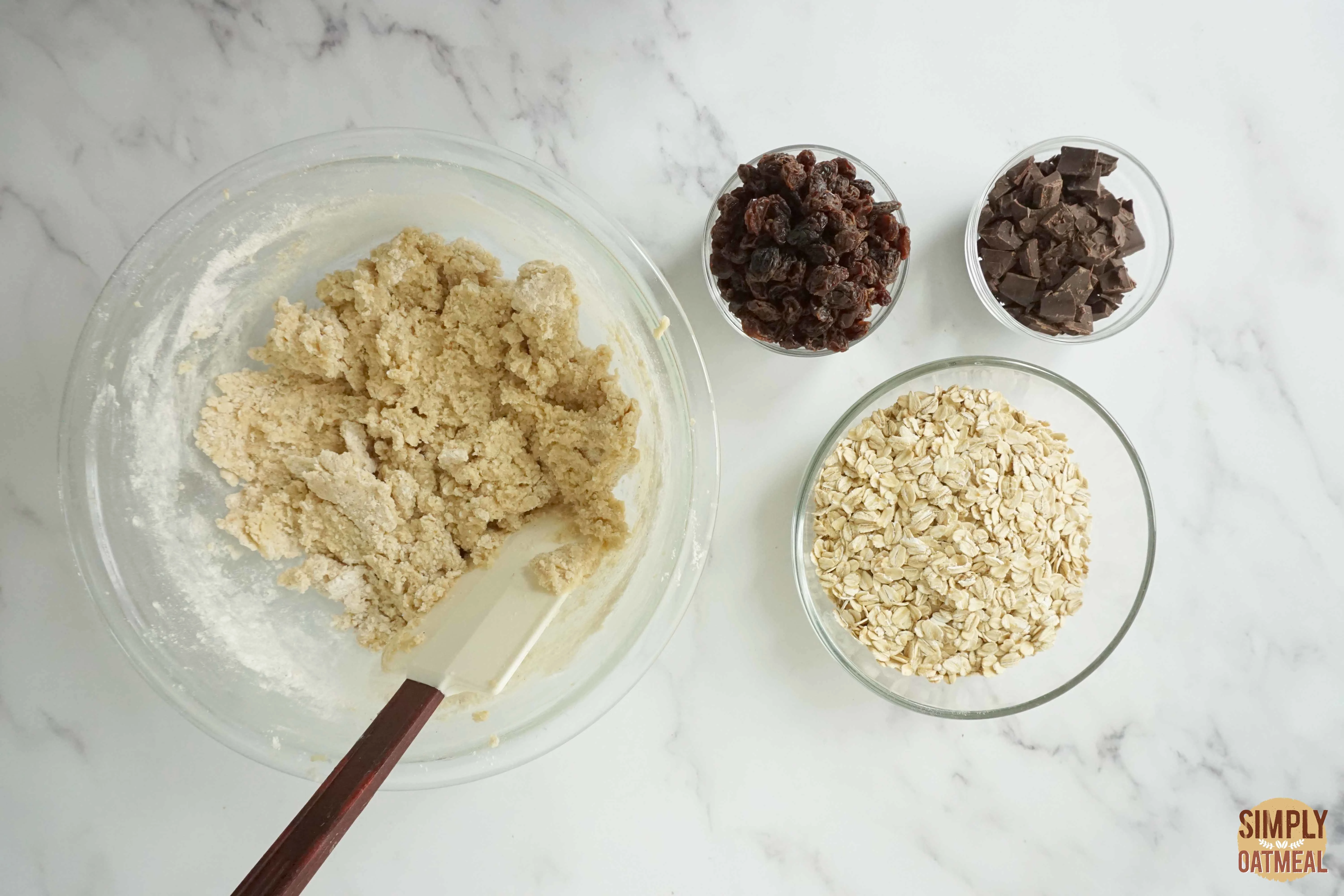 Wet and dry ingredients to make oatmeal raisin cookies