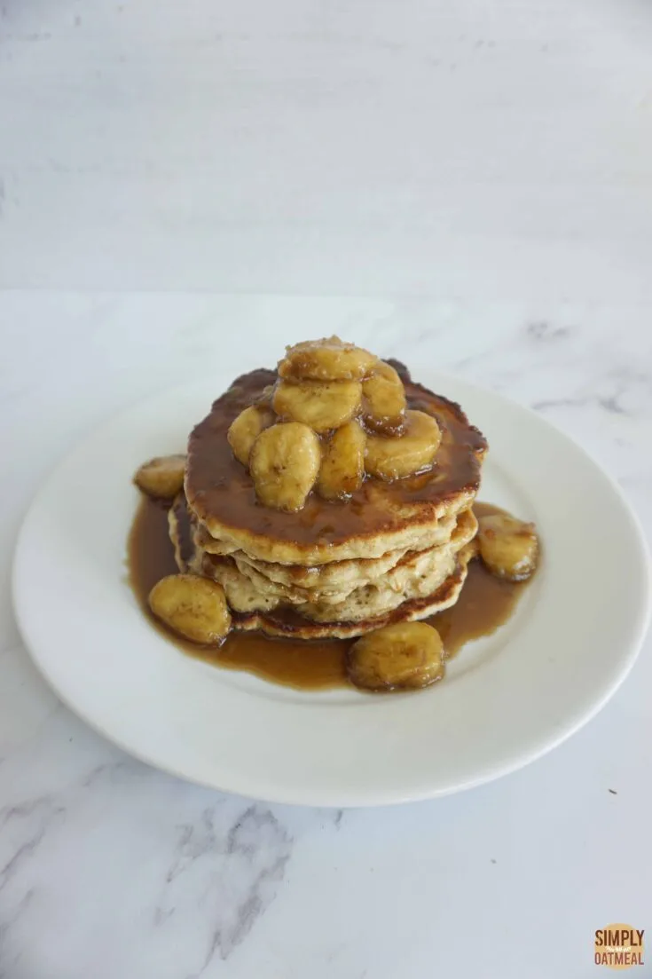 Banana butterscotch oatmeal pancakes stacked on a plate