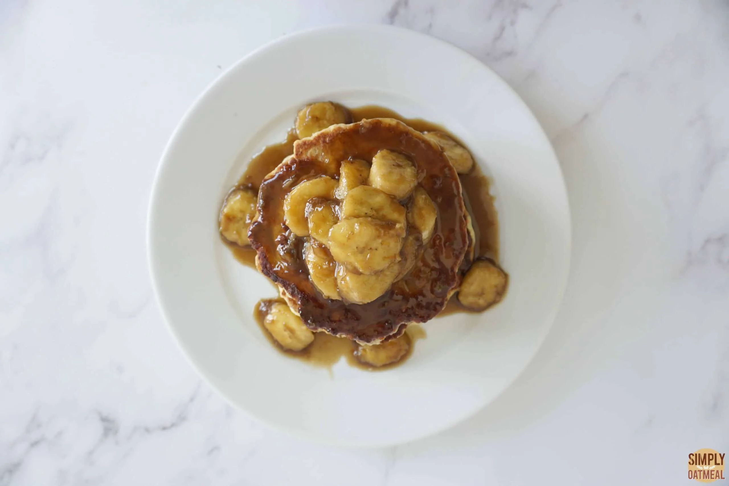 Oatmeal pancakes topped with banana butterscotch sauce