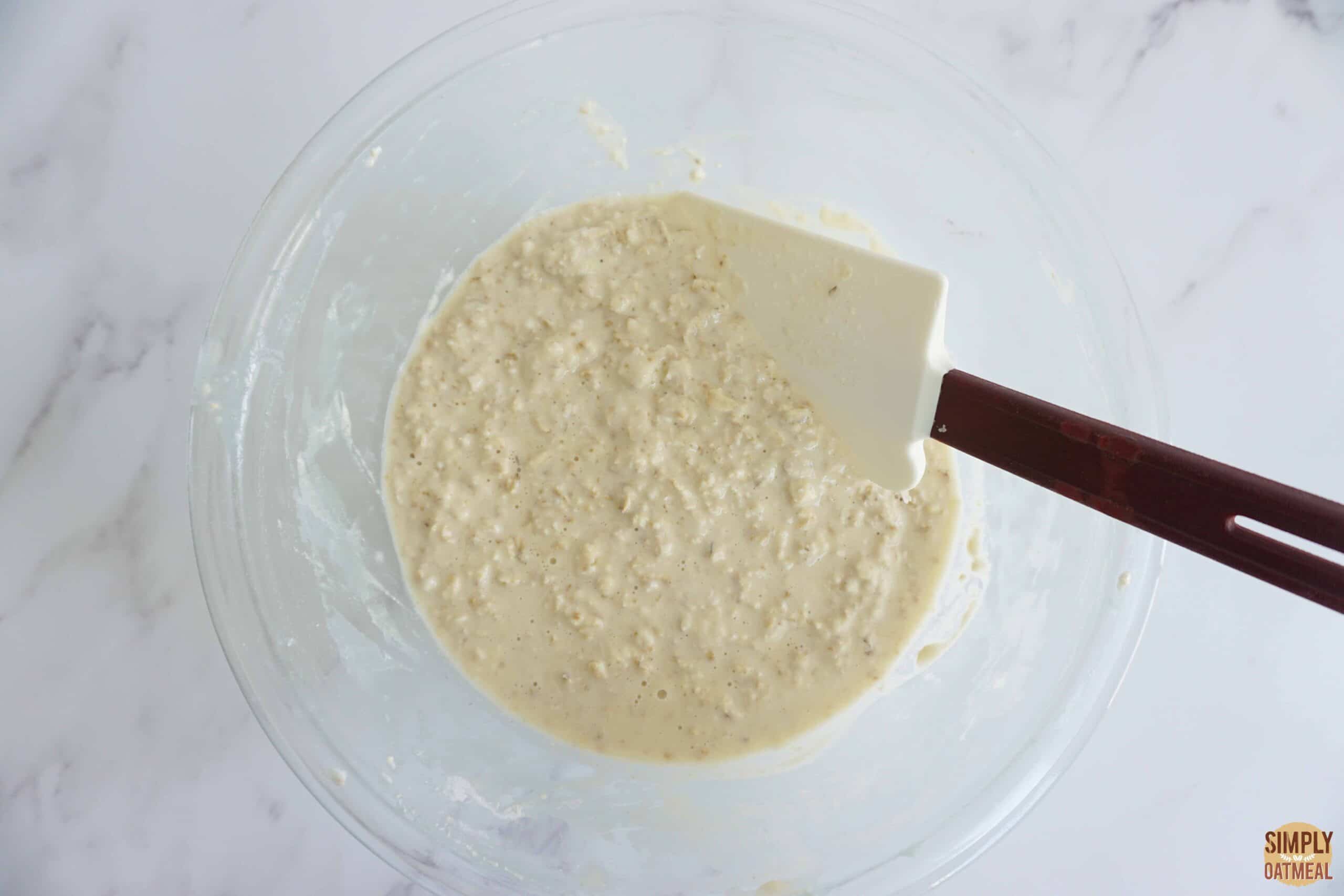 Raw coconut oatmeal pancake batter in a mixing bowl.