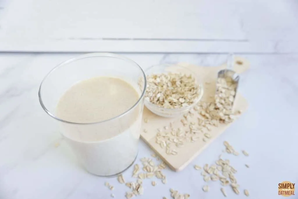Oat milk like oatly with rolled oats sprinkled on the side