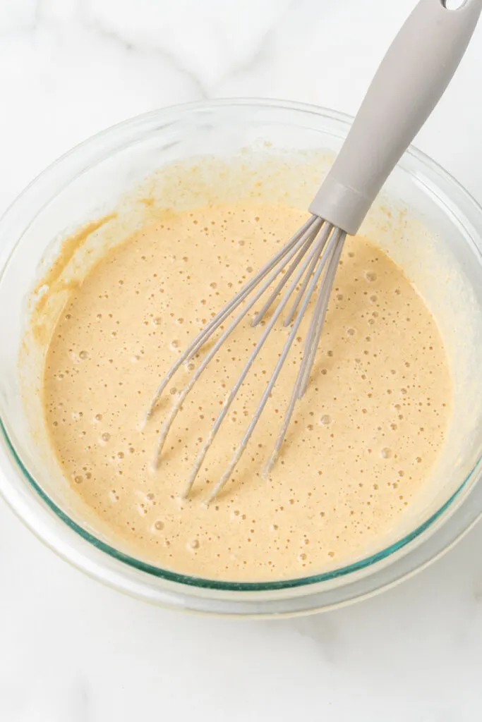 Whisk with waffle batter.