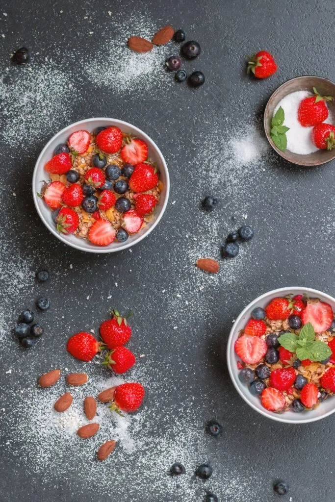 Bowls of strawberries and blueberries.
